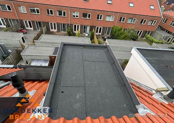 Plat dak met bitumen bedekking naast dakkapel in Brabant